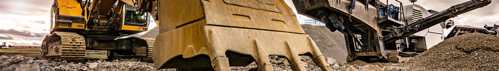 Picture of two excavators moving earth and debris.