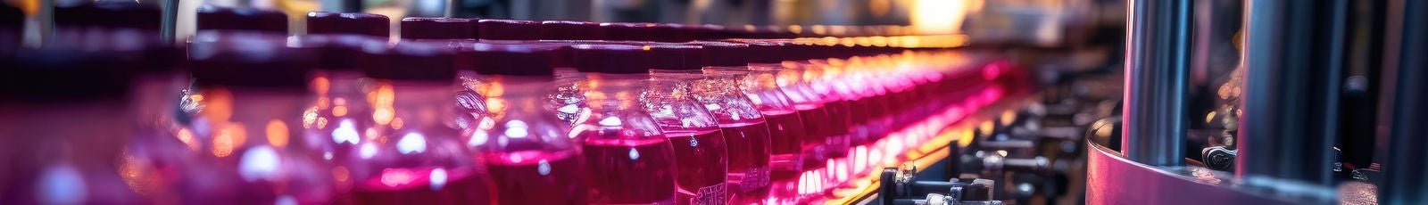 Image of bottled beverages being assembled on conveyor belt.